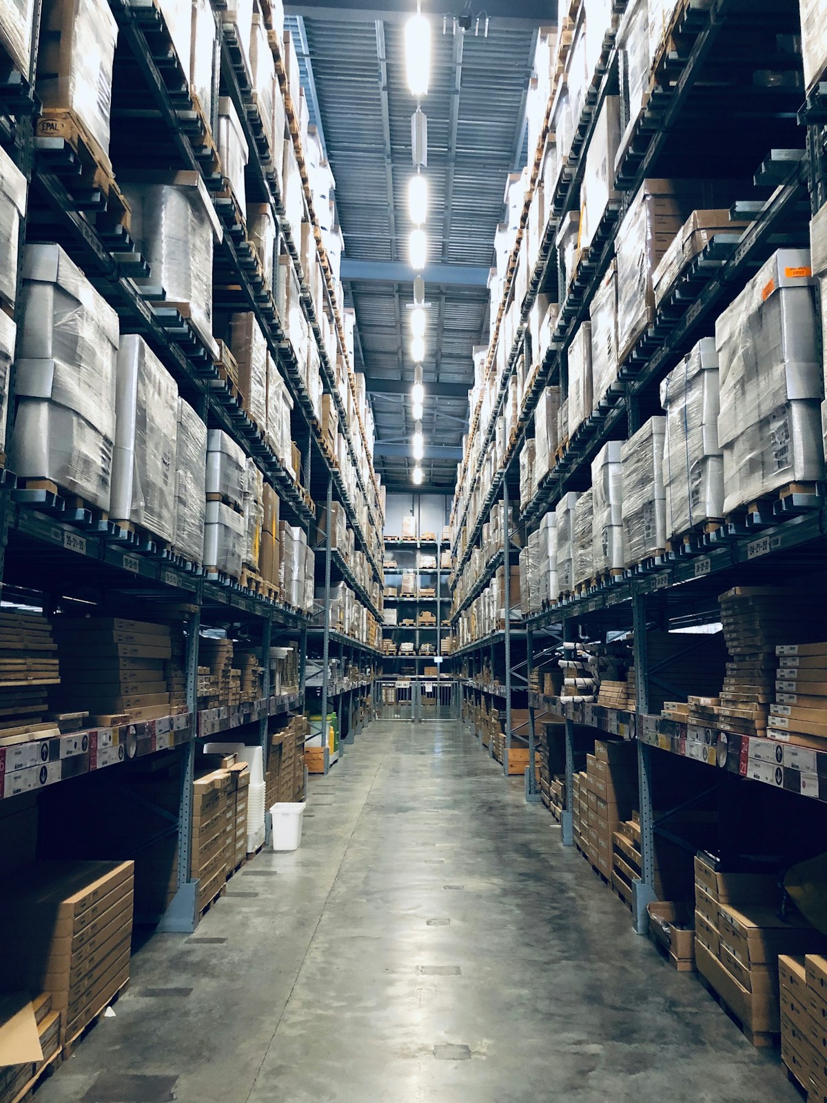 Workers and automation inside a modern warehouse facility